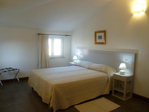 a hotel room with a bed and a desk at Albergo Residenziale La Corte in Tortolì