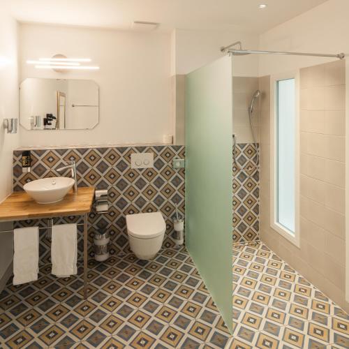 a bathroom with a toilet and a sink at B&B Louis-Favre 21 in Neuchâtel