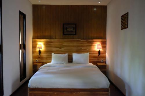 Krevet ili kreveti u jedinici u objektu Puri Minggiran Guest House
