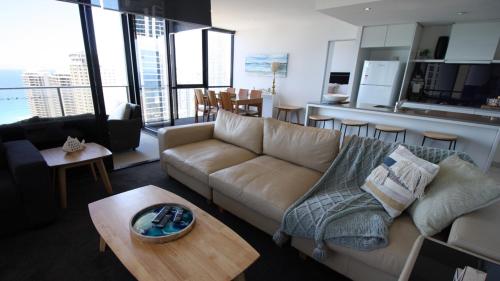 a living room filled with furniture and a large window at Cavill Avenue Luxury Private Apartments in Gold Coast