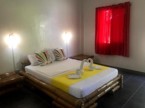 a bedroom with a bed with two swans on it at Neptune Diving Resort Santander in Santander