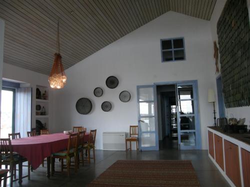 a kitchen and dining room with a pink table and chairs at Casa da Ermida de Santa Catarina in Santa Eulália