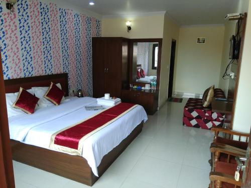 a bedroom with a large bed and a mirror at Basant Watika in Mussoorie