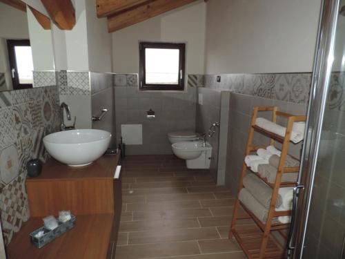 a bathroom with a sink and a toilet and a shower at Il Bambuseto in Fossano