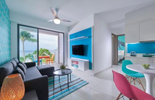 a living room with a couch and a table at Cassia Bintan, part of Banyan Group in Lagoi