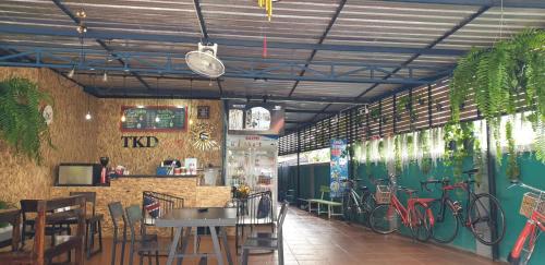 a restaurant with bikes painted on the walls at Khaohom House in Chiang Mai