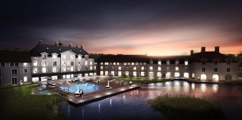 a large building with a pool in the middle of the water at Staycity Aparthotels near Disneyland Paris in Bailly-Romainvilliers