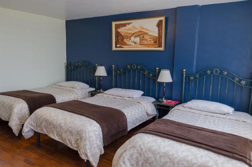Postel nebo postele na pokoji v ubytování Hotel El Altar