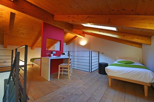 a bedroom with a bed and a desk in a room at Casa Sobrero in Castiglione Falletto