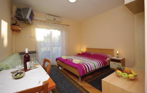 a bedroom with a bed and a table with a table sidx sidx sidx at Apartments Ljubica in Makarska