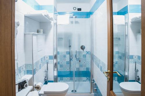 a bathroom with a shower and a toilet at Vittoria Guest House Salerno in Salerno