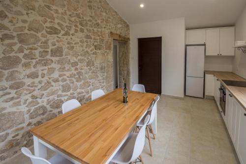 a kitchen and dining room with a wooden table and chairs at Stara kuća Estate in Ljubuški