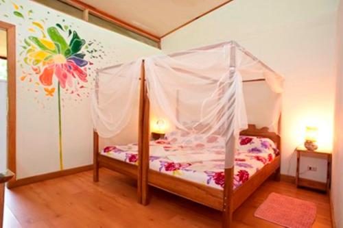 a bedroom with a bed with a canopy at Blue Conga in Puerto Viejo