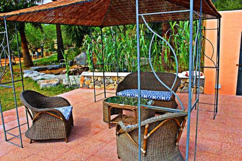 a gazebo with two chairs and a table at Agroturismo Can Fuster in Sant Joan de Labritja