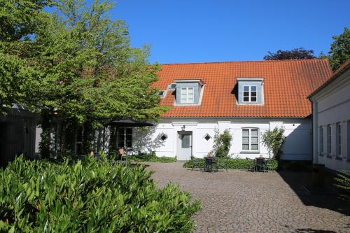 a white house with an orange roof at Tune Kursuscenter in Greve