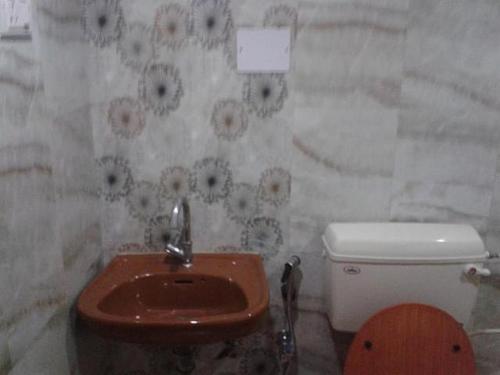 a bathroom with a toilet and a sink at Stay at Tito's Lane in Marmagao