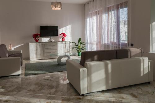 a living room with a couch and a tv at XX Settembre Matera - Apartment in Matera