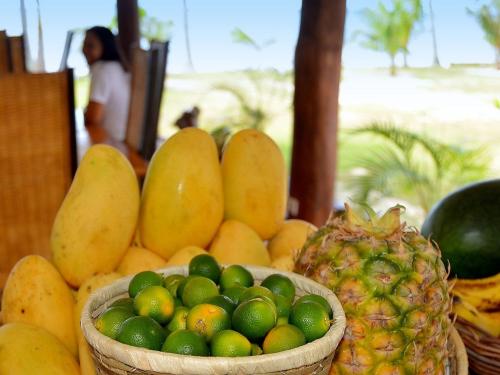 a basket of fruit sitting on a table with a pineapple at White Villas Resort in Siquijor