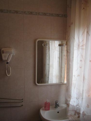 a bathroom with a sink and a mirror at Flavia Flats in Bibione
