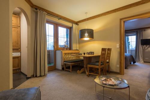 a living room with a table and a bedroom at Villa Haidacher Relax & Lifestyle Apartments in Zell am Ziller