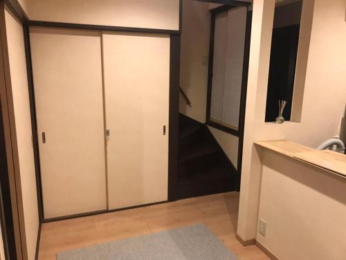 a bathroom with a sliding door in a room at FUUTEI Japanese-style lodge in Kyoto