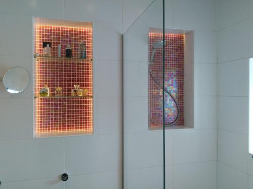 a bathroom with a shower with a glass door at Hotel De Wilde Kriek in Valkenburg