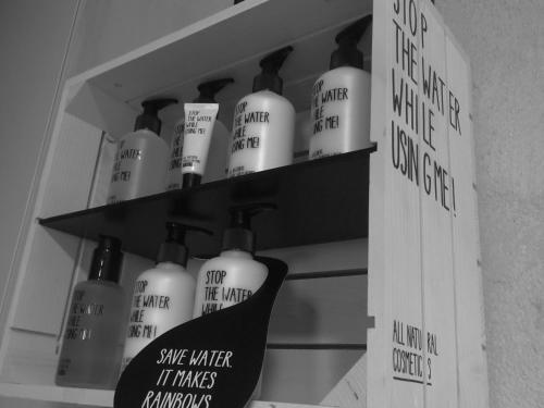 a shelf filled with lots of bottles of soap at Villa Haidacher Relax & Lifestyle Apartments in Zell am Ziller