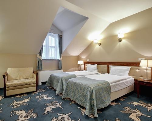 Posteľ alebo postele v izbe v ubytovaní Hotel Koronny