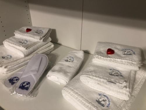a group of towels on a counter in a bathroom at l’Ancora luxury apartment in Genova