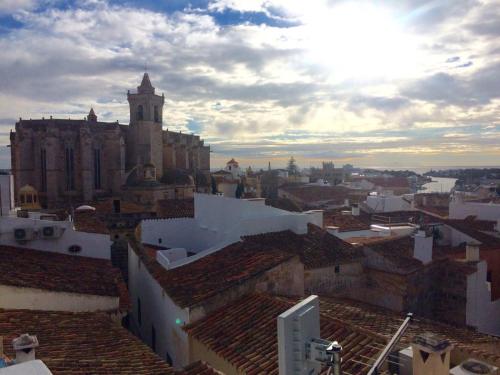 a view of a city with a church and roofs at Can Araya in Ciutadella