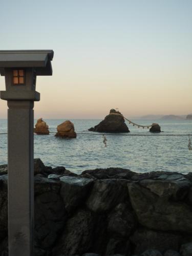 a view of the ocean with rocks in the water at Futami Terrace B in Ise