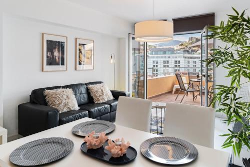 a living room with a couch and a table at Arriaga I by An Island Apart in Funchal