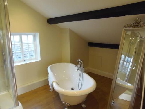 a bathroom with a bath tub and a shower at Bay House in Broadway