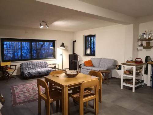 a living room with a table and a couch at La tana del riccio in San Sisto dei Valdesi