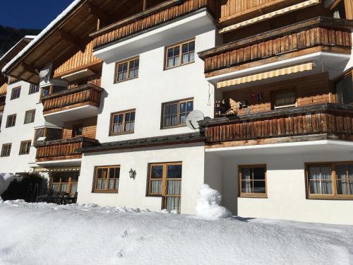 a snowman in front of a building in the snow at Ferienwohnung Scheibe in Neustift im Stubaital