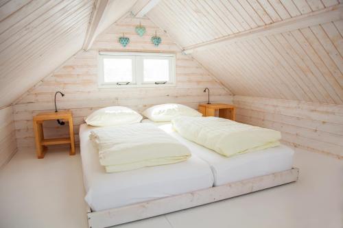 a bedroom with two beds in a attic at Surf en beach strandhuisjes in Katwijk