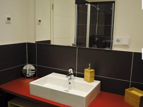 a bathroom with a white sink and a mirror at Zum Jakobi 1 in Goslar