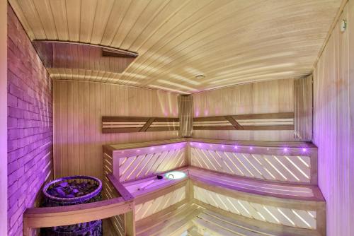 a sauna with purple lighting in a room at Aisha Bibi Hotel & Spa in Astana