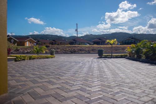 a brick parking lot with houses in the background at Villa Sophia in Mammee Bay
