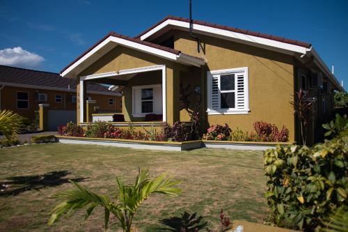 a house with a garden in front of it at Villa Sophia in Mammee Bay