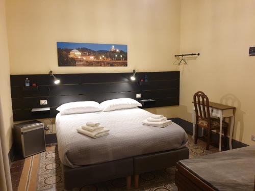 a bedroom with a bed with two towels on it at Tuscany Experience BnB in Foiano della Chiana