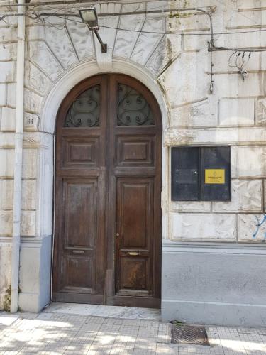 a large wooden door on the side of a building at Le Stanze di Piazza Cairoli in Messina
