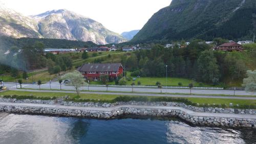 a bridge over a river in a valley with mountains at Ingrids Apartments in Eidfjord