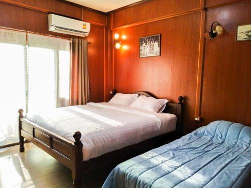 Una cama o camas en una habitación de Kantawan House