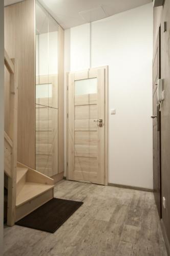 a bathroom with a white door and a mirror at Dream Team Pomorska in Bydgoszcz