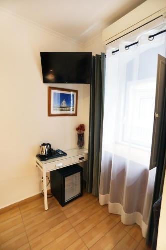 a room with a desk and a window at Anjo Azul in Lisbon