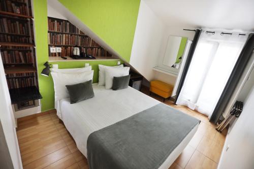 a bedroom with a large bed with green walls at Anjo Azul in Lisbon