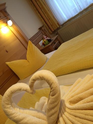 a bedroom with two swans made out of towels at Waldhotel Seebachschleife in Bayerisch Eisenstein