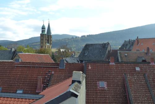 a view of roofs of a city with a clock tower at Zum Jakobi 1 in Goslar