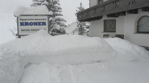 a pile of snow in front of a building at Appartements Kroner in Nauders